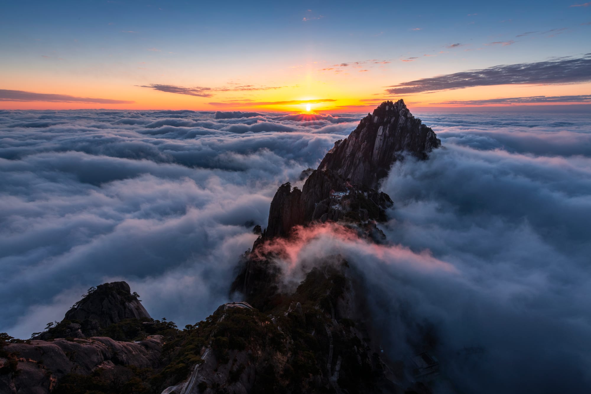 Sunrise above a sea of clouds and mountain peaks in Huangshan