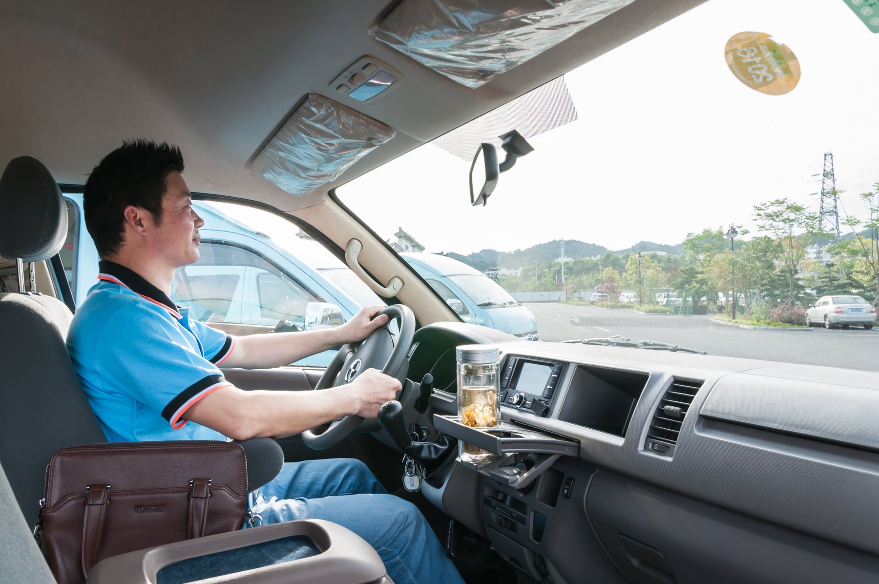 A Huangshan tourism driver at the wheel of a local passenger vehicle